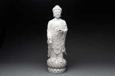 A large Chinese Dehua blanc de Chine figure of Buddha holding a lotus, He Chaozong 何朝宗 and Dehua 德化 mark, 20th C.
