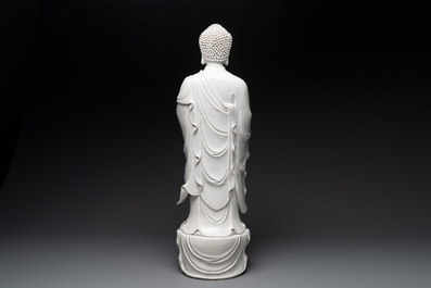 A large Chinese Dehua blanc de Chine figure of Buddha holding a lotus, He Chaozong 何朝宗 and Dehua 德化 mark, 20th C.