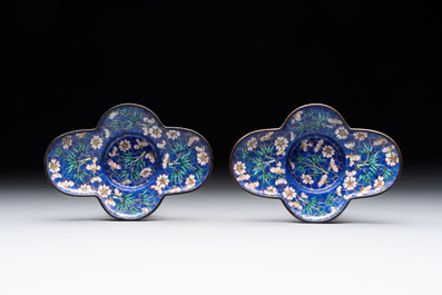 A pair of Chinese blue-ground Canton enamel covered bowls on stands and an egg cup, Qianlong/Jiaqing