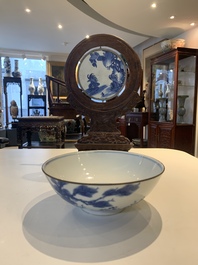 A Chinese blue and white 'Bleu de Hue' 'roosters and chick' plaque in a carved wooden screen and a bowl, 19th C.