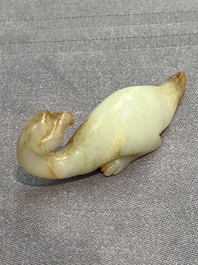 Three Chinese celadon and russet jade carvings of animals, 19th C.