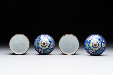 A pair of Chinese blue-ground Canton enamel covered bowls on stands and an egg cup, Qianlong/Jiaqing