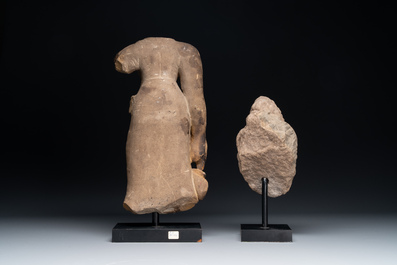 A sandstone female torso and a Buddha head, Cambodia, late Khmer period, 13/14th C.