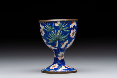 A pair of Chinese blue-ground Canton enamel covered bowls on stands and an egg cup, Qianlong/Jiaqing
