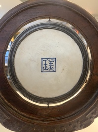 A Chinese blue and white 'Bleu de Hue' 'roosters and chick' plaque in a carved wooden screen and a bowl, 19th C.