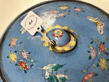 A Chinese Canton enamel blue-ground circular hand mirror, early 19th C.