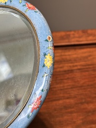 A Chinese Canton enamel blue-ground circular hand mirror, early 19th C.