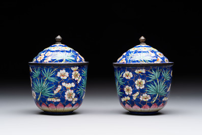 A pair of Chinese blue-ground Canton enamel covered bowls on stands and an egg cup, Qianlong/Jiaqing