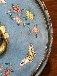 A Chinese Canton enamel blue-ground circular hand mirror, early 19th C.