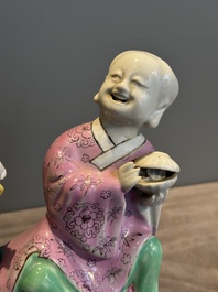 A Chinese famille rose 'Hehe Erxian' group on a wooden stand, Qianlong