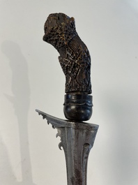 A collection of six krises with carved handles, four with scabbard, Indonesia, 19th C.