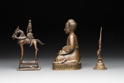 A Burmese gilt bronze Buddha, an Indian bronze Shiva on horseback and and a Nepalese Melong ritual mirror with Ganesh, 18/19th C.
