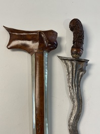 A collection of six krises with carved handles, four with scabbard, Indonesia, 19th C.