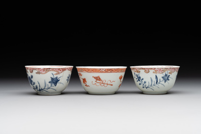 A pair of Chinese polychrome-decorated cups and saucers and an iron-red gilt-decorated cup and saucer, Yongzheng/Qianlong