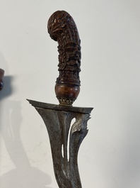 A collection of six krises with carved handles, four with scabbard, Indonesia, 19th C.