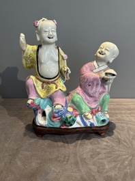 A Chinese famille rose 'Hehe Erxian' group on a wooden stand, Qianlong
