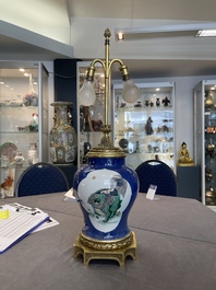 A Chinese famille verte  powder-blue-ground 'mythical animal' vase with gilt bronze lamp mounts, 19th C.