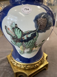 A Chinese famille verte  powder-blue-ground 'mythical animal' vase with gilt bronze lamp mounts, 19th C.