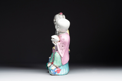 A Chinese famille rose 'Hehe Erxian' group on a wooden stand, Qianlong