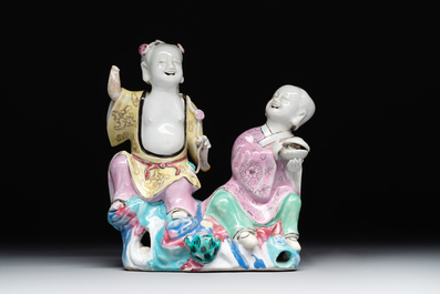 A Chinese famille rose 'Hehe Erxian' group on a wooden stand, Qianlong