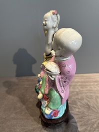 A Chinese famille rose 'Hehe Erxian' group on a wooden stand, Qianlong