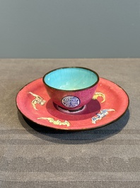 A rare Chinese Canton enamel ruby-ground 'Bats and Shou' cup on stand, Qianlong mark and of the period