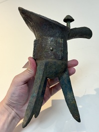 A Chinese archaic bronze wine vessel with taotie design, 'jue 爵', Zhou