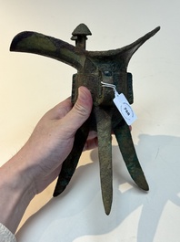 A Chinese archaic bronze wine vessel with taotie design, 'jue 爵', Zhou
