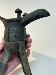 A Chinese archaic bronze wine vessel with taotie design, 'jue 爵', Zhou