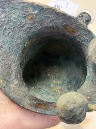A Chinese archaic bronze wine vessel with taotie design, 'jue 爵', Zhou
