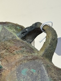 A Chinese archaic bronze wine vessel with taotie design, 'jue 爵', Zhou