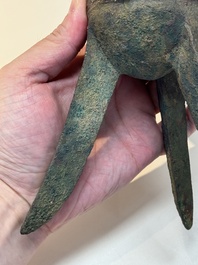A Chinese archaic bronze wine vessel with taotie design, 'jue 爵', Zhou