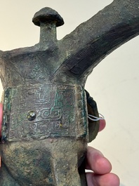 A Chinese archaic bronze wine vessel with taotie design, 'jue 爵', Zhou
