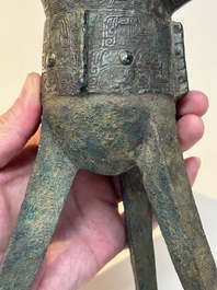 A Chinese archaic bronze wine vessel with taotie design, 'jue 爵', Zhou