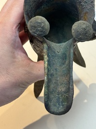 A Chinese archaic bronze wine vessel with taotie design, 'jue 爵', Zhou