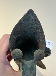 A Chinese archaic bronze wine vessel with taotie design, 'jue 爵', Zhou