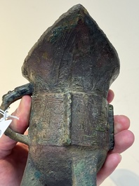 A Chinese archaic bronze wine vessel with taotie design, 'jue 爵', Zhou