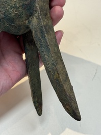 A Chinese archaic bronze wine vessel with taotie design, 'jue 爵', Zhou