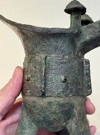 A Chinese archaic bronze wine vessel with taotie design, 'jue 爵', Zhou