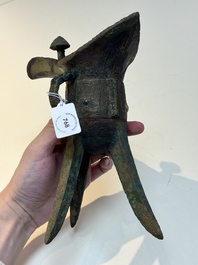 A Chinese archaic bronze wine vessel with taotie design, 'jue 爵', Zhou