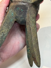 A Chinese archaic bronze wine vessel with taotie design, 'jue 爵', Zhou