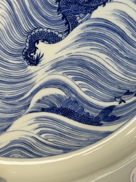 A rare large imperial Chinese blue and white 'dragon and carps' basin, Kangxi mark and of the period