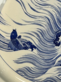 A rare large imperial Chinese blue and white 'dragon and carps' basin, Kangxi mark and of the period