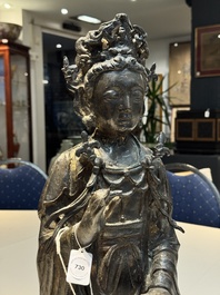 A large Chinese bronze Bodhisattva on wooden stand, Ming