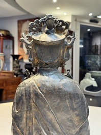 A large Chinese bronze Bodhisattva on wooden stand, Ming