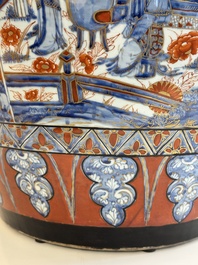 A large Chinese European-decorated blue and white fish bowl with narrative design, on a later wooden stand, Kangxi