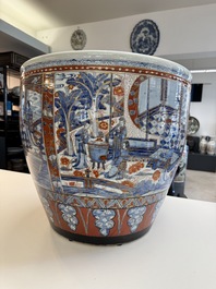 A large Chinese European-decorated blue and white fish bowl with narrative design, on a later wooden stand, Kangxi