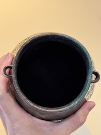 A Chinese archaic bronze inscribed wine vessel with scale design, 'hu 壺', Zhou
