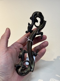 A Chinese bronze 'dragon' brush rest, Song/Yuan