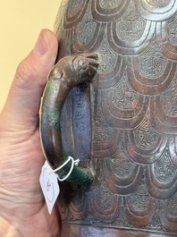 A Chinese archaic bronze inscribed wine vessel with scale design, 'hu 壺', Zhou